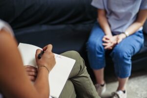 therapist and client talk in a session about the benefits of cbt