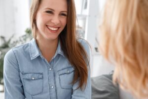 woman smiles at friend while learning how to deal with trauma