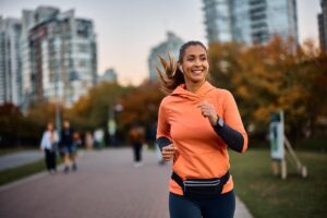 woman runs outdoors after learning about the connection between exercise and mental health wellness
