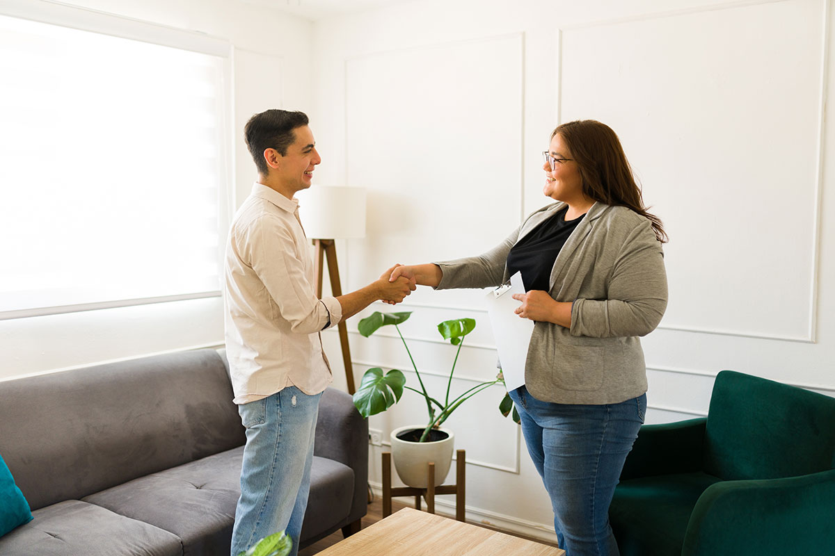 Man and women shaking hands in OCD treatment therapy