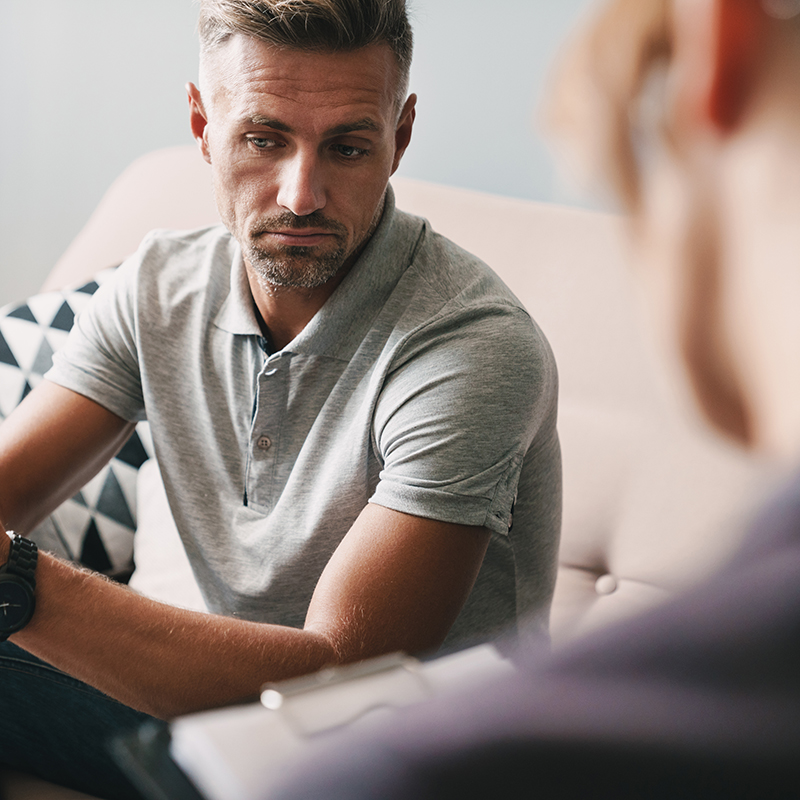 man thinking about what to say about his depression treatment to his therapist