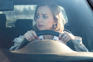 worried woman is driving and thinking about the myths about anxiety