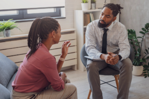 a woman is talking to her therapist in treatment for ptsd in the fox chapel area