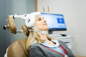 a patient sits in a chair undergoing tms therapy for depression