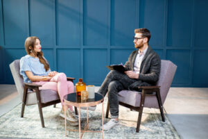 a psychiatrist in bloomfield clinic sits and talks with a patient