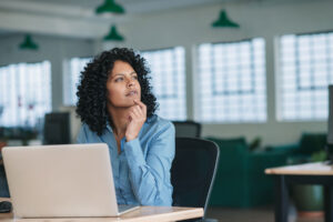 woman sitting at a desk thinking about what is neurodiversity