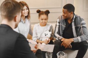 a family sits together while in a family therapy session and a therapist talks to them