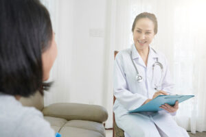 medical professional talks to patient about tms therapy