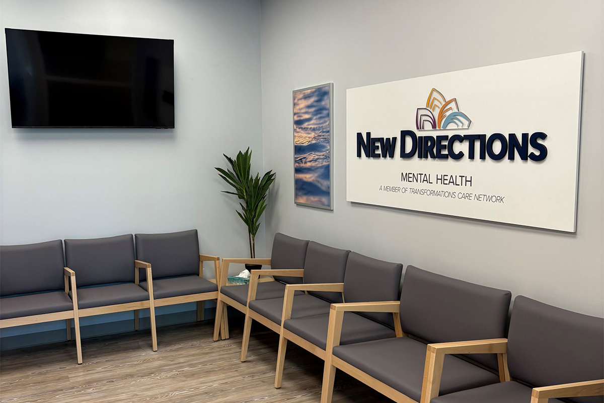 Chairs lining wall under New Directions indoor sign in waiting room